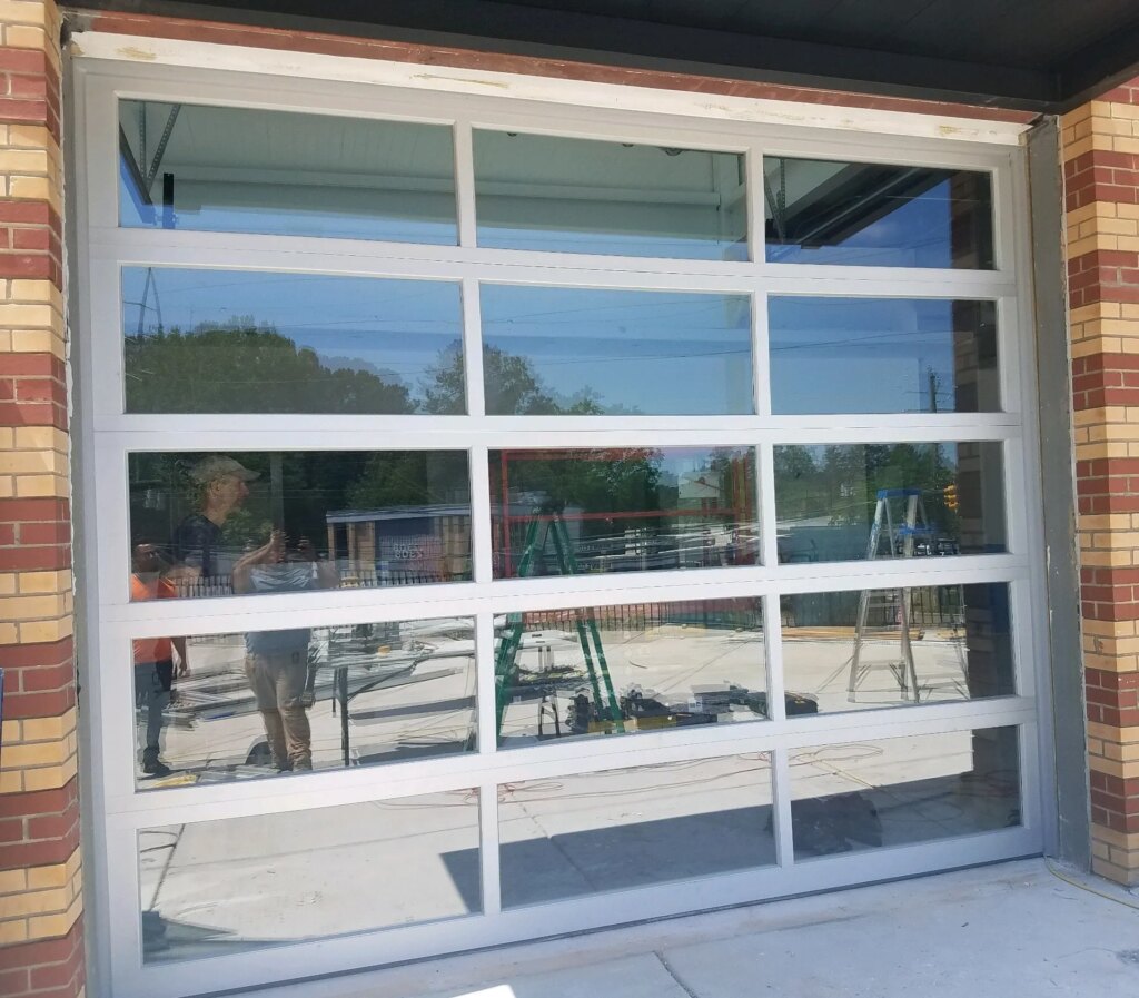 Exterior view of full view glass commercial garage door in Raleigh, NC