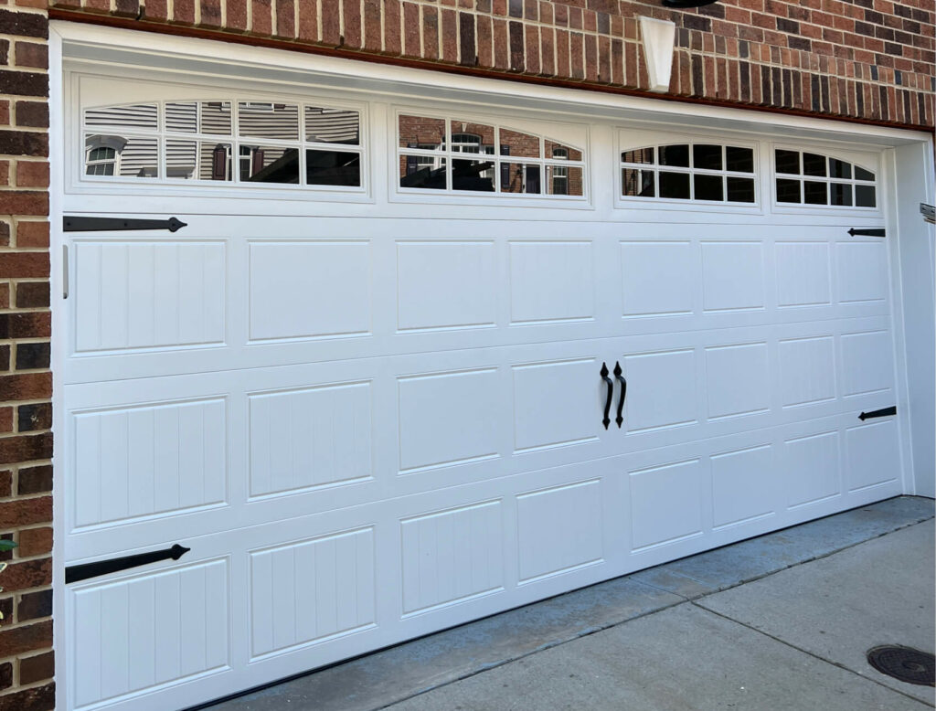 Garage Door Panel Repair: Expert Advice on Fixing vs. Replacing - Carriage-panel-with-Arched-glass-decorative-hardware-e1715799125594-1024x778