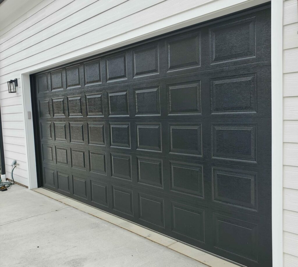 Garage Door Panel Repair: Expert Advice on Fixing vs. Replacing - Raised-panel-garage-door-black-scaled-e1715799277100-1024x917