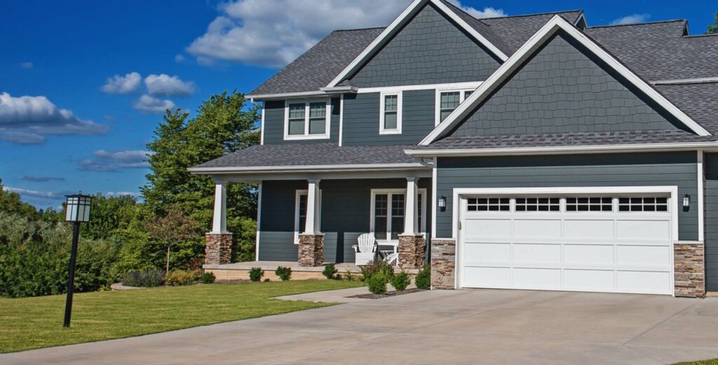 Blue/gray house with white double garage door